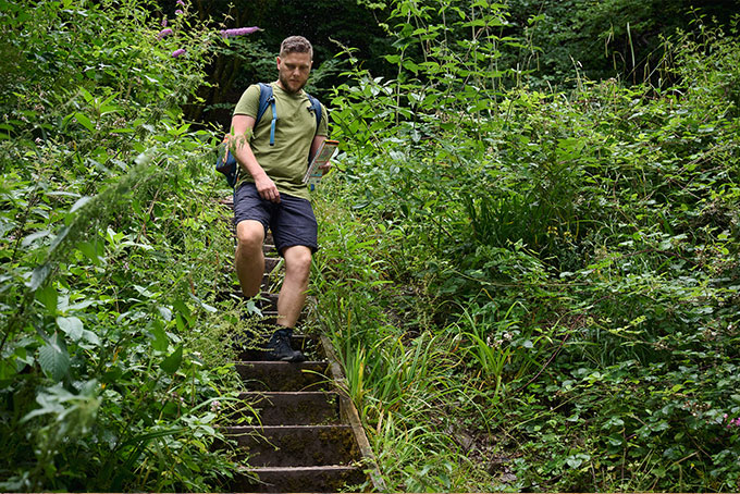 Woman in watermelon Mac in a Sac rain poncho