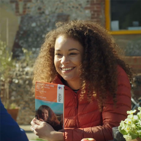 Woman holding personalised map with her photo on cover